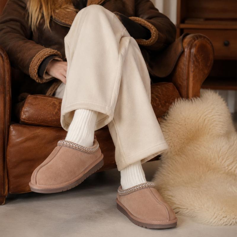 Close view of the taupe braided clogs worn with an everyday outfit