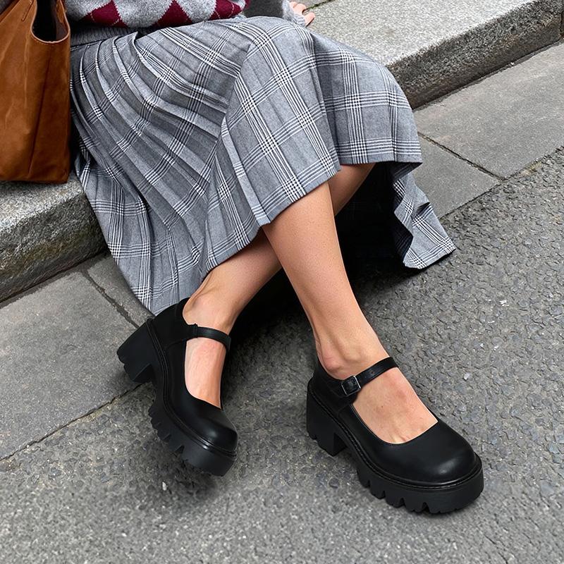 Smooth black platform Mary Janes styled with a grey plaid skirt