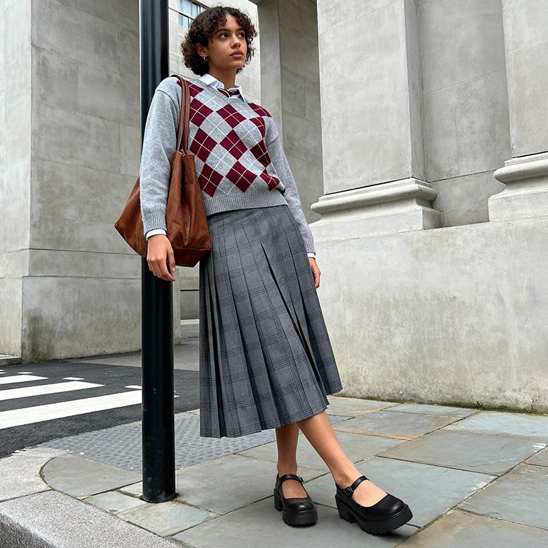 Platform Mary Janes styled with an argyle knit and a plaid midi skirt