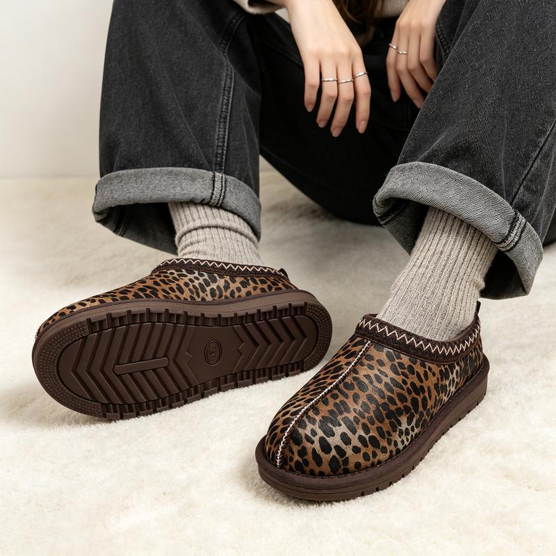 Leopard-print braided clogs styled with charcoal jeans and ribbed socks